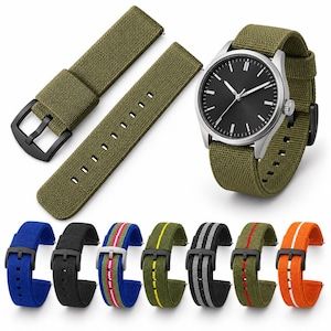 May include: A wristwatch with a black dial and silver case featuring an olive green canvas strap, accompanied by an extra olive green strap and seven additional canvas watch straps in blue, black, striped blue, striped olive, striped black, striped green, and orange.