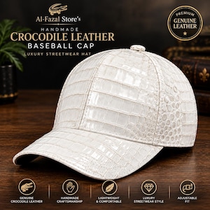 May include: A white baseball cap crafted from textured crocodile leather. The cap features a structured crown, a curved brim, and a button at the top. The surface displays the distinct scale pattern of crocodile skin with a glossy finish.