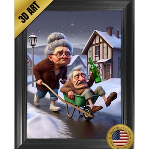 May include: A framed 3D art print featuring an elderly person in a brown cardigan pushing a green wheelbarrow containing another elderly person holding a green glass bottle. The scene is set in a snowy village with houses and a street lamp.