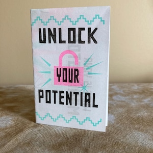 May include: A white card with a teal border and the text "UNLOCK YOUR POTENTIAL" in black. A pink padlock with a keyhole is in the center of the card.