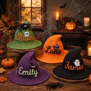May include: Four knitted witch hats in green, orange, purple, and black. The green hat features a spider and skull with the name Oliver. The orange hat has a cat with a tiny hat and the name Luna. The purple hat has a mini hat and the name Emily. The black hat has a ghost and the name James.
