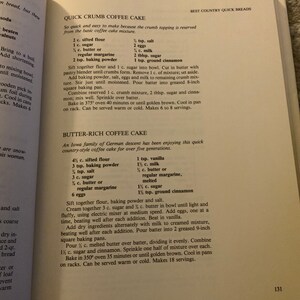 May include: A vintage cookbook page with two recipes for coffee cake: Quick Crumb Coffee Cake and Butter-Rich Coffee Cake. The recipes list ingredients and instructions for baking the cakes.