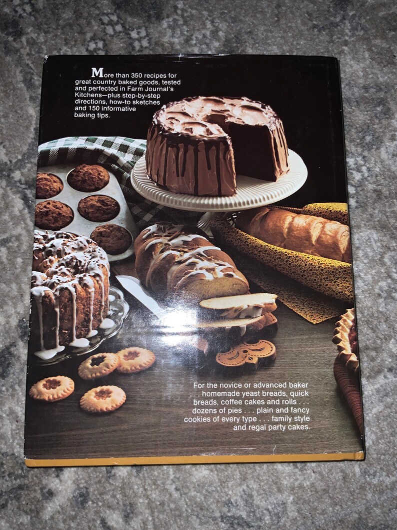May include: A cookbook cover featuring a variety of baked goods, including a chocolate cake with chocolate frosting, a loaf of bread, and a variety of cookies. The text on the cover reads "More than 350 recipes for great country baked goods, tested and perfected in Farm Journal's Kitchens - plus step-by-step directions, how-to sketches and 150 informative baking tips."
