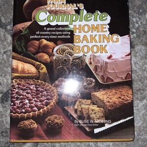 May include: A vintage cookbook titled "Farm Journal's Complete Home Baking Book" with a collection of country recipes. The cover features a variety of baked goods, including pies, cakes, and bread.