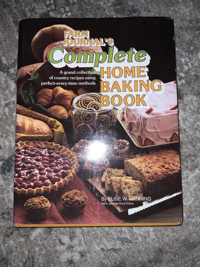 May include: A vintage cookbook titled "Farm Journal's Complete Home Baking Book" with a collection of country recipes. The cover features a variety of baked goods, including pies, cakes, and bread.
