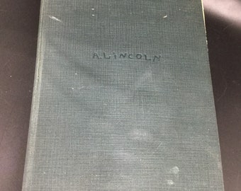 May include: A dark green hardcover book with the word "LINCOLN" embossed on the front cover.