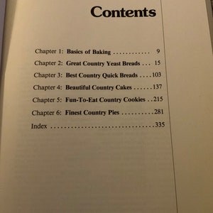 May include: A book titled "Country Cooking" with a table of contents listing chapters on baking, breads, cakes, cookies, and pies.