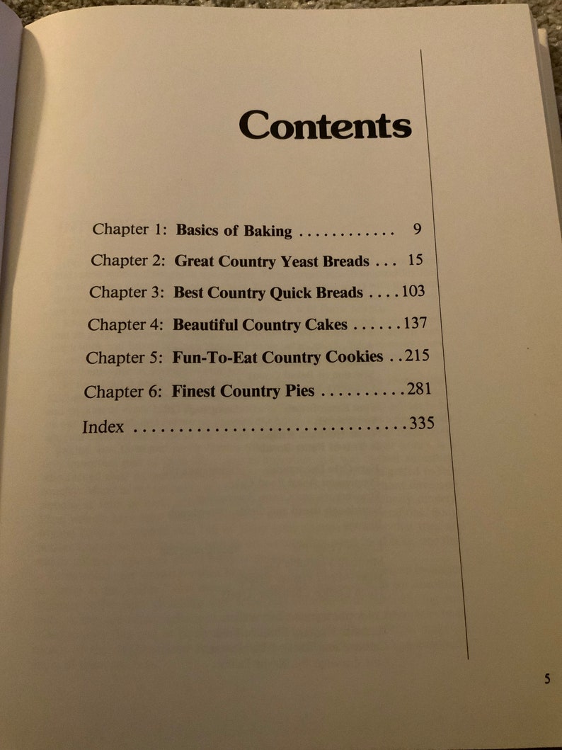 May include: A book titled "Country Cooking" with a table of contents listing chapters on baking, breads, cakes, cookies, and pies.