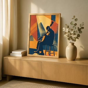 May include: A rectangular framed art print featuring a dark blue silhouette of a person playing a cello while seated on a stool. The background consists of abstract geometric shapes in shades of yellow, red, and blue, with a bright yellow light beam.