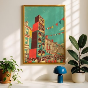 May include: A framed wall art print depicting a tall, stacked tower of colourful loudspeakers standing in a crowded street scene. The illustration features red and teal speaker cabinets, festive triangular bunting flags, and rows of urban buildings.