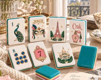 May include: A set of rectangular mahjong tiles featuring colorful illustrations including a peacock, a masquerade mask labeled Joker, the Eiffel Tower, a perfume bottle labeled Crak, the number 8, the number 7, and the Sacré-Cœur Basilica.