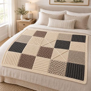 May include: A square crochet blanket featuring a patchwork design of alternating squares in cream, beige, light brown, and dark charcoal gray. The squares display various textured patterns including ribbed, bobble, and cross-stitch designs.