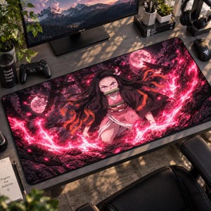 May include: A rectangular desk mat featuring a vibrant anime illustration of a character with long dark hair, pink eyes, and a bamboo muzzle. The character is surrounded by glowing pink energy, dark rocky terrain, and a large full moon in the background.