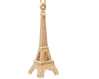 May include: A gold-colored Eiffel Tower charm pendant. The charm is detailed with intricate designs and is perfect for adding a touch of Parisian flair to jewelry.
