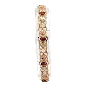Whispers of Romance: Vintage 10k Black Hills Gold Bracelet Adorned with Deep Red Garnets