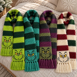 May include: Four crocheted scarves featuring horizontal stripes and a stitched character face at the bottom. The scarves are lime green and dark green, teal and dark green, purple and dark gray, and cream and dark red, all with matching tassels.