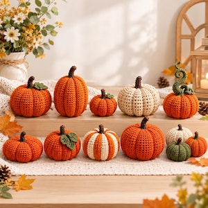 May include: A collection of twelve crocheted pumpkins in various sizes and colors, including solid orange, cream, and green. The pumpkins feature textured yarn stitches, brown stems, and some include small green crocheted leaves or curly vines.