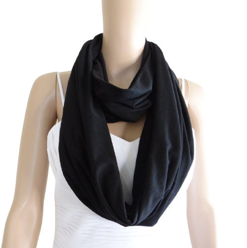 May include: A black infinity scarf made of soft fabric.