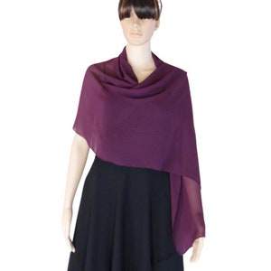 May include: A purple chiffon shawl draped over a black dress. The shawl is lightweight and sheer, with a soft, flowing drape.
