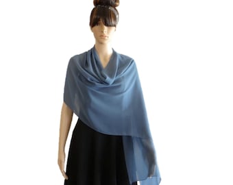 May include: A light blue chiffon shawl draped over a mannequin. The shawl is a simple, elegant design that can be worn for a variety of occasions.