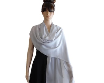 May include: A light gray chiffon shawl draped over a mannequin. The shawl is made of a soft, flowing fabric and is perfect for adding a touch of elegance to any outfit.