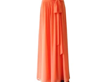 May include: A long, flowing orange maxi skirt with a tie waist. The skirt is made of a lightweight, sheer fabric.