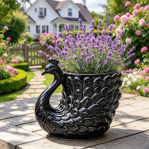 May include: A glossy black ceramic planter shaped like a peacock with detailed embossed feather patterns on its body. The planter is filled with a vibrant bunch of purple lavender flowers, showcasing a long neck and head.