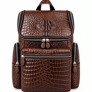 May include: A brown backpack featuring a textured crocodile skin pattern. The bag includes a top handle, a main compartment with a zip closure, a front zipped pocket, and two side zipped pockets, all accented with silver-toned hardware.