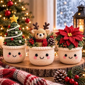 May include: Three crocheted amigurumi figures in cream-colored pots with smiling faces. The left pot holds a green Christmas tree with a yellow star. The center pot features a reindeer with a red scarf. The right pot contains a red poinsettia.
