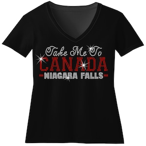 A black t-shirt with the text "Take Me to Canada Niagara Falls" printed on it in red and white.