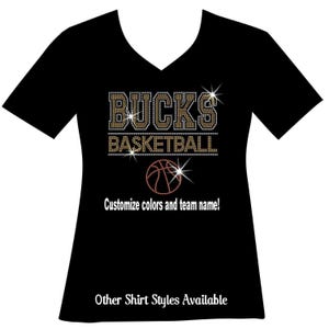 Custom basketball bedazzled bling shirt. Your team name. Your choice of 2colors. The name outlined. A line, then basketball. A line then an orange basketball. You can customize your team name and team colors. Varsity font and thousands of rhinestones