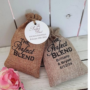 May include: Two burlap bags with the text "The Perfect Blend" printed on them. One bag has the names Lucas & Daniella and the date February 20th 2024. The other bag has the names Brittany & Bryan and the date 6/12/24.