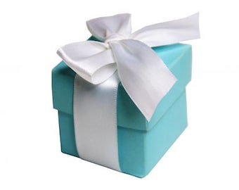 May include: A small, light blue gift box with a white satin ribbon and bow.
