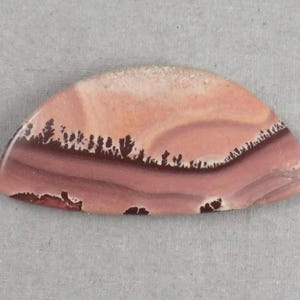 May include: A set of three ceramic mugs with a speckled, matte finish. Each mug features a different color: light blue, cream, and gray. The mugs have a simple, modern design with a rounded shape and a handle.