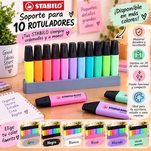 May include: A grey 3D-printed plastic stand holding ten Stabilo Boss highlighters in various colours, including yellow, orange, pink, purple, blue, and green. Two additional highlighters lie horizontally on the surface in front of the stand.