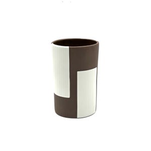 May include: A cylindrical ceramic tumbler featuring a matte dark brown exterior contrasted by two vertical, rectangular white panels with a fine ribbed texture. The vessel has a smooth, open top and a flat base, showcasing a clean, geometric design.