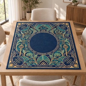 May include: A square Mahjong table mat in deep blue with gold and teal art deco patterns. The center features a circular border with text including White Dragons, Green Dragons, Red Dragons, Craks, Bams, and Dots. Corners display Charleston rules.