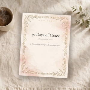 May include: A book titled 30 Days of Grace with a soft pink watercolour background and a gold leaf-patterned border. The cover features the text Luxe Honu, 30 Days of Grace, A Devotional for Women, and 30 daily readings to begin each morning in grace.