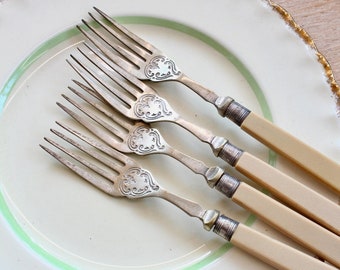 Set of Five Electroplate Fish Forks with faux bone handles.