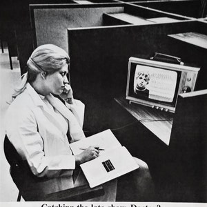 May include: Monochrome image featuring a woman in a white coat observing a vintage television. The screen shows a person's face and a waveform. The text "DOCTOR OF TOMORROW" is at the top, and "Catching the late show, Doctor?" at the bottom.