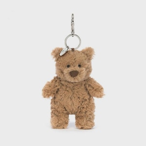 May include: A light brown plush teddy bear keyring featuring soft, textured fur, a dark brown stitched nose, and small rounded ears. The bear is attached to a silver-toned metal split ring and a lobster claw clasp for secure attachment to items.
