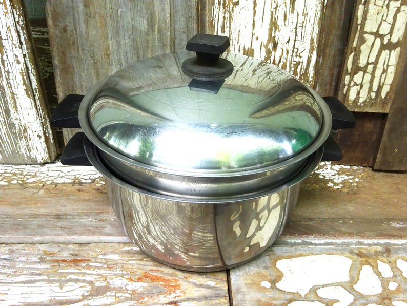 May include: A stainless steel stockpot with a matching lid and black heat-resistant handles on both sides. The pot features a polished metallic finish, a rounded body, and a secure-fitting lid with a central black knob for easy handling.