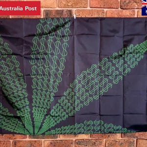 May include: A rectangular black flag featuring a large, stylized leaf graphic composed entirely of repeating green dollar sign symbols. The flag has a white vertical strip along the left edge with metal grommets for hanging, displaying a bold, graphic pattern.