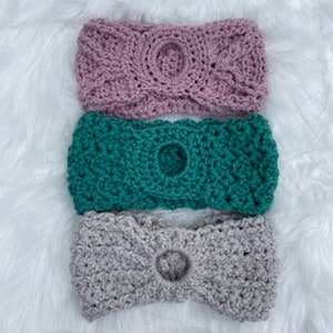 May include: Three crocheted headbands in pink, teal, and gray. Each headband has a hole in the center.