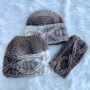 May include: Two brown and white crocheted hats with a cable knit pattern and a matching brown crocheted headband.
