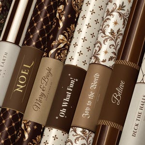 May include: A collection of wrapping paper rolls featuring various holiday-themed designs in shades of brown, cream, and gold. The rolls display text including Peace on Earth, Noel, Merry & Bright, Oh What Fun, Joy to the World, Believe, and Deck the Halls.