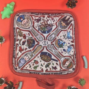May include: A square, off-white pot holder with a red border, featuring illustrations of food and characters. The design includes spoons, a knife, and the text "Delicious in Dungeon".