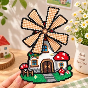 Puede incluir: Una decoración de molino de viento estilo pixel art hecha con cuentas de plástico fundido. El molino presenta un edificio blanco con puerta marrón, ventanas azules y grandes aspas. Setas rojas y blancas decoran la base verde.