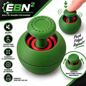 Puede incluir: Un juguete fidget impreso en 3D de color verde y rojo con un mecanismo de émbolo central. El dispositivo cuenta con una base esférica y un botón superior circular. El texto en la imagen incluye EBN2, BUILT BY MAKERS FOR MAKERS, SILENT, SATISFYING TACTILE FEEL, COMPACT & LIGHTWEIGHT, DURABLE 3D PRINTED, PERFECT FOR ON THE GO, Push Fidget Repeat!, y SMOOTH MULTI-DIRECTIONAL MOVEMENT.