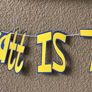 May include: A yellow and blue banner with the text "Wyatt is 7!" and a red and white Pokeball on the left and a yellow Pikachu character on the right.